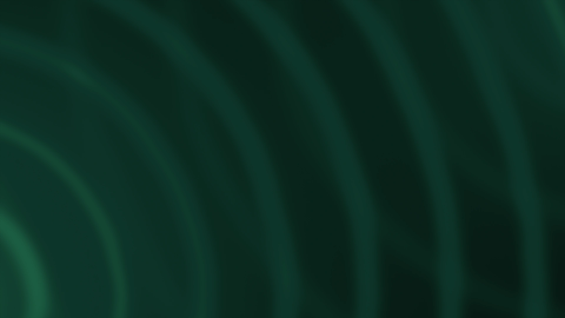Soft emerald light fading into a dark charcoal gradient